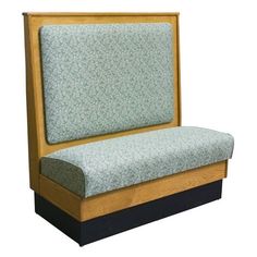 a wooden bench with a green and blue upholstered seat cover on it's back