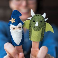 a person holding two finger puppets in their hands