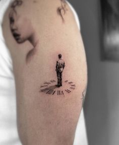 a man with a clock tattoo on his arm