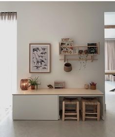 a white room with shelves and stools on the wall