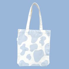 Holy Cow! This blue cow tote bag is seriously aMOOsing! There’s nothing better than a blue cow print on one side with an adorable blue cow on the other side! All of our designs are double-sided so that you have the option to wear a more simple look, or a more bold look! Our tote bags also have an inner pocket! It is the perfect size to hold your phone, wallet, chapstick, and any little trinkets so you don’t have to dig around the bottom of your tote bag! Features: Inner pocket Fits laptop Spacious compartment Double-sided design Designed in Australia Artwork by Mel Instagram: melbdesign_ Material: 100% Cotton Calico Approximate Dimensions: Length: 40cm, Width: 34cm Handle length: 35cm Pocket: 17cm x 17cm Care instructions: Hand wash with cold water and leave to air-dry. Do not leave in dir Design Totebag, Tote Bag Pattern Paint, Tote Bag Aesthetic Design, Light Blue Summer Tote Bag, Fun White Tote Bag, Tote Bags Aesthetic, Trendy Hand Painted Tote Bag, Handpainted Tote, Fun Blue Tote Bag