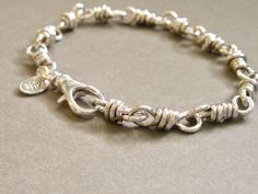 Hand-wrapped chain link bracelet in sterling silver. Each handmade link from 16 gauge wire forms a substantial base for this simple staple piece. Finished in a sterling lobster clasp, the bracelet is polished to a high shine. Great alone or layered with other bracelets. This bracelet is sturdy and completely closed, so there's no concern about losing links. Enjoy it for a lifetime and pass it on to a family member! Sterling silver stamp and makers mark charm attached to lobster. When selecting t Silver Chain Style, Jewelry Unique, Unique Gifts For Her, Wire Bracelet, Silver Pieces, Staple Pieces, Chain Link Bracelet, Makers Mark, Link Bracelets