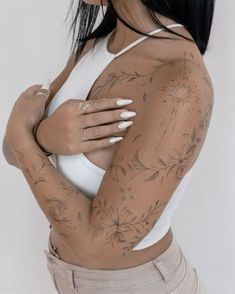 a woman with tattoos on her arms and chest