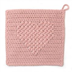 a pink crocheted potholder with a knot on the side