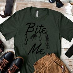 Bite Me Fishing Shirt | Mens Fishing T shirt | Funny Fishing Shirt | Fishing Graphic Tee | Fisherman Gifts | Father's Day Gift  MATERIAL & SIZE: * Soft, comfortable, and lightweight unisex tee *  A stretchy and flattering fit * Unisex Fitting: See size chart in photos for best match * 100% combed and ring-spun cotton (Heather colors contain polyester) * Heather colors are 52% combed and ring-spun cotton, 48% polyester * Fabric weight: 4.2 oz (142 g/m2) * Pre-shrunk fabric CARE INSTRUCTIONS: * Wash in cold water, in-side out * Gentle cycle with like colors * Tumble dry low, or line dry for longest life Fishing Tshirt Designs, Funny Fishing Shirts Men, Fishing Graphic, Funny Fishing Shirts, Cheap Casual T-shirt For Fishing, Graphic Tee T-shirt For Fishing, Father's Day Fishing T-shirt With Short Sleeves, Funny Fishing, Boy Fishing