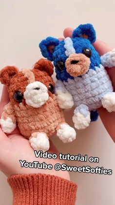 two small crocheted dogs are being held in their hands