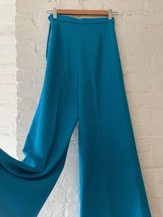 Fun wide leg pants in textured azure blue fabric. Size zipper + button closure.  There are no tags, but would best fit an XXS.  Waist measures 12.5" laying flat, with some stretch to fabric.  There is a stain near the back bottom of the right leg, please see pictures. Chic High Waist Light Blue Wide Leg Pants, Blue Full-length Evening Pants, Blue Full Length Evening Pants, Evening Blue Full Length Pants, Blue Wide-leg Evening Bottoms, Blue Wide Leg Evening Bottoms, Chic Blue Wide Leg Culottes, Blue Wide Leg Bottoms For Evening, Spring Blue Wide Leg Pants