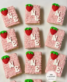 strawberry shortbreads decorated with pink frosting and strawberries are arranged in the shape of numbers