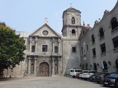 an old church with cars parked in front