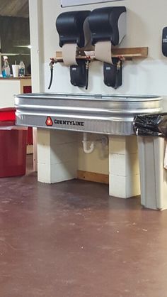 there is a metal bench in the middle of a room with two skateboards on it