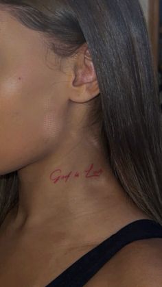 a woman with a tattoo on her neck saying, hope is love in red ink