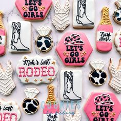 decorated cookies are arranged on a marble countertop with pink and white frosting, black lettering that says let's go girls