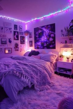 a bedroom with purple lights and pictures on the wall