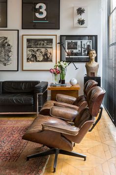 a living room filled with furniture and pictures on the wall