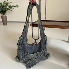 Elevate your fit with this washed Denim Shoulder Bag. Effortlessly cool with a side of grunge, this bag is perfect for adding a touch of Y2K flare to any outfit. Whether you're on an adventure or a night out, this bag will keep your essentials close and your look on point. Dimensions: 41x42x9cm (approximately) Jean Bag Aesthetic, Handbag Poses, Outfits Extra, Gothic Casual, Upcycled Bags, Videos Ramdom, Future Aesthetic, Y2k Belt, Bag Y2k