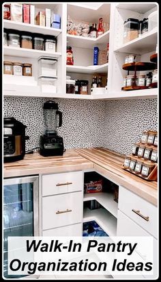 an organized pantry with white cabinets and wooden counter tops