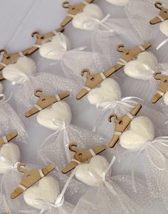 small wooden clothes pins are tied with string and placed in organ bags on a table