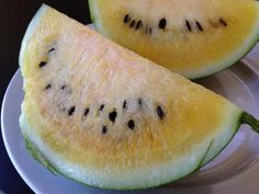 two slices of watermelon on a white plate