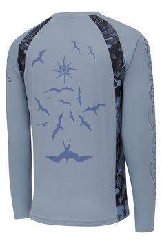 a blue shirt with birds flying in the sky and stars on it's sleeves