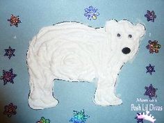 a white polar bear sitting on top of a blue surface next to snowflakes