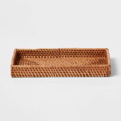 a woven rectangular tray on a white background