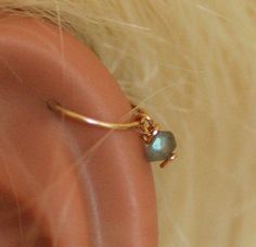 ❤️ SINGLE HOOP WITH TINY CLAPS + wire wrapped faceted LABRADORITE bead stone. Perfect for ALL piercings: nose, helix, ear, tragus, cartilage, snug, lower / upper earlobe, 2nd and 3rd piercings. ► Please choose material for your hoop: 100% 14K gold filled 100% Silver Sterling ►Please choose inner DIAMETER for your hoop: 6/7 mm (snug/tragus piercing fit) 8 mm (common for all types- nose, upper earlobe fit) 9/10 mm (lower earlobe) 11 mm (conch fit) Everyones facial features are different ☺ To get a Gold Wire Wrapped Cartilage Earrings As Gift, Gold Wire Wrapped Cartilage Earrings For Gift, 3rd Piercings, Piercings Nose, Ear Peircings, Gold Nose Hoop, Earring Cartilage, Helix Ear, Helix Piercing Jewelry