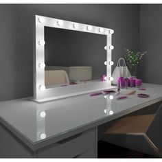 a vanity mirror with lights on top of it next to a chair and vase filled with flowers