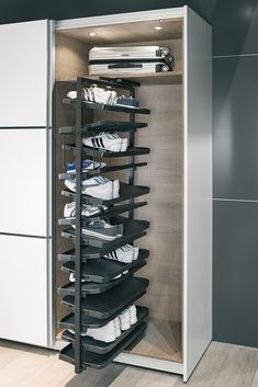 the closet is full of shoes and other items in it's storage compartment,