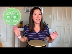 a woman holding a drum in front of her face with the words sounds in the woods