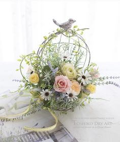 a bouquet of flowers sitting on top of a table next to a magazine and ribbon