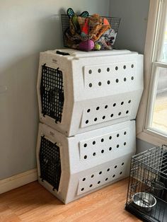 three large dog crates stacked on top of each other in front of a cat door