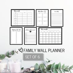 the family wall planner set of 6 is shown with candles and greenery in front of it