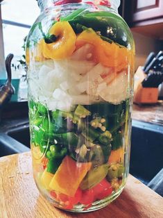 a jar filled with different types of vegetables