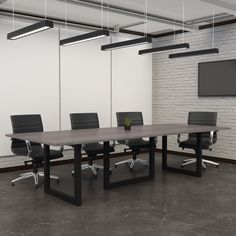 an empty conference table with black chairs and a flat screen tv mounted on the wall