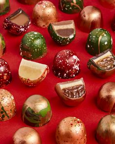 many different types of chocolates on a red surface