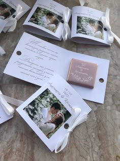 wedding favors and pictures are laid out on the table