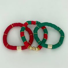 three red, green and gold bracelets with bells