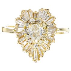 1980's classic diamond Ballerina style engagement ring. 1 pear shaped .38cts center stone. Mounted in a 18k yellow gold heart shaped setting with two diamond halos, one with 11 round brilliant cut diamonds and the second with 26 baguette shaped diamonds in a ballerina style setting. 1 pear shape diamond, K SI2 approx. .38cts 11 round brilliant cut diamonds, I-J VS SI approx. .13cts 26 baguette diamonds, G-H VS SI approx. .75cts Size 5.5 and sizable 18k yellow gold Tested: 18k 5.1 grams Width at Ballerina Engagement Ring, Whimsical Winter Wedding, Ballerina Ring, Heart Shaped Diamond Ring, Baguette Engagement Ring, Ballerina Style, Baguette Diamonds, Heart Shaped Diamond, Pear Shaped Diamond