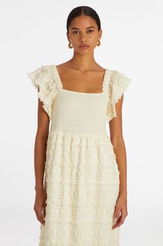 Our Kora Dress in Blanc features a smocked bodice, gorgeous textural embroidery and fringe as well as a flattering square neck.   -Square neck with smocked top panel  -Side Pockets  -Lined Skirt  -Fringe detail fabric  -100% Cotton  -True to size Chic Smocked Dress With Square Neck, White Smocked Top With Ruffles And Square Neck, Elegant Smocked Top With Square Neck And Ruffles, Elegant Smocked Top With Ruffles And Square Neck, White Smocked Dress With Square Neck, Elegant Smocked Bodice Top With Square Neck, Chic Smocked Top With Square Neck, Chic Smocked Square Neck Top, Chic Smocked Top With Ruffle Hem And Square Neck