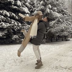 a woman is walking in the snow with her coat on