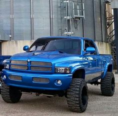 a blue truck parked in front of a building