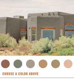 an adobe style house in the desert surrounded by trees and bushes with text that reads choose a color above