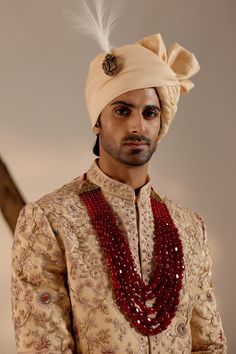 Pale Gold Sherwani | Jatin Malik Introducing our exquisite golden heavy hand-embroidered sherwani set, a true work of art. This sherwani features an intricate embroidery technique combining zardosi and aari work, showcasing unparalleled craftsmanship and attention to detail. Perfect for those seeking to make a grand and sophisticated statement, this sherwani set epitomizes luxury and traditional elegance. Included in purchase: Sherwani, Kurta, Churidar Product Specification Color: Golden Fabric: Linen silk Occasion: Engagement, Wedding, Bridal, Reception Style: Sherwani, Kurta, Churidar Care: Dry Clean Work: Hand Embroidery Customization options:Can be customized in any color or style Note: A stylist will contact you to confirm measurements after your order is placed.Estimated delivery tim Luxury Spring Sherwani With Gota Work, Luxury Brocade Sherwani With Intricate Embroidery, Luxury Banarasi Silk Sherwani With Zari Weaving, Luxury Gold Brocade Sherwani, Luxury Cotton Silk Sherwani With Pallu, Naqshi Lehenga For Festive Traditional Ceremonies, Naqshi Lehenga For Traditional Ceremonies And Festive Occasions, Festive Lehenga With Naqshi For Traditional Ceremonies, Traditional Naqshi Drape In Raw Silk