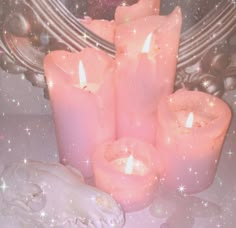 a group of pink candles sitting on top of a table