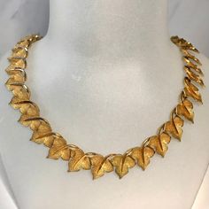 "1960s-70s articulated gilt leaves necklace.  Sits beautifully & comfortably around the neck. Leaves all the way around, with a hook over clasp. Lovely textured finish to the leaf shaped, with a shiny finish to their stems.  With the leaf design running all the way round this means this is great worn with short hair, or when longer hair is in an up do, it looks great all the way round.  On close inspection I can see a tiny bit of wear to the gilding, mainly on the leaf stems & mostly towards eit Vintage Gold Leaf Jewelry, Vintage Gold Leaf-shaped Jewelry, Leaves Necklace, Longer Hair, Floral Spray, The Leaf, Hand Painted Flowers, Candy Stripes, Wedding Jewellery Necklace