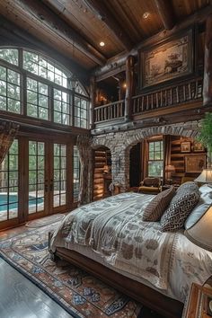 a large bed sitting in a bedroom next to a tall wooden building with lots of windows