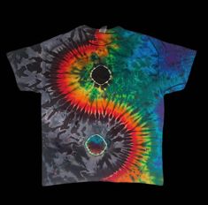 a tie - dyed t - shirt with an image of the yin yang symbol on it