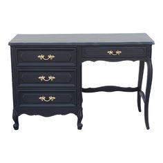 a black desk with three drawers and gold trimmings on the top, against a white background