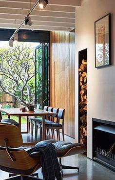 a living room filled with furniture and a fire place in front of a sliding glass door