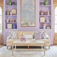 a living room filled with furniture and purple walls